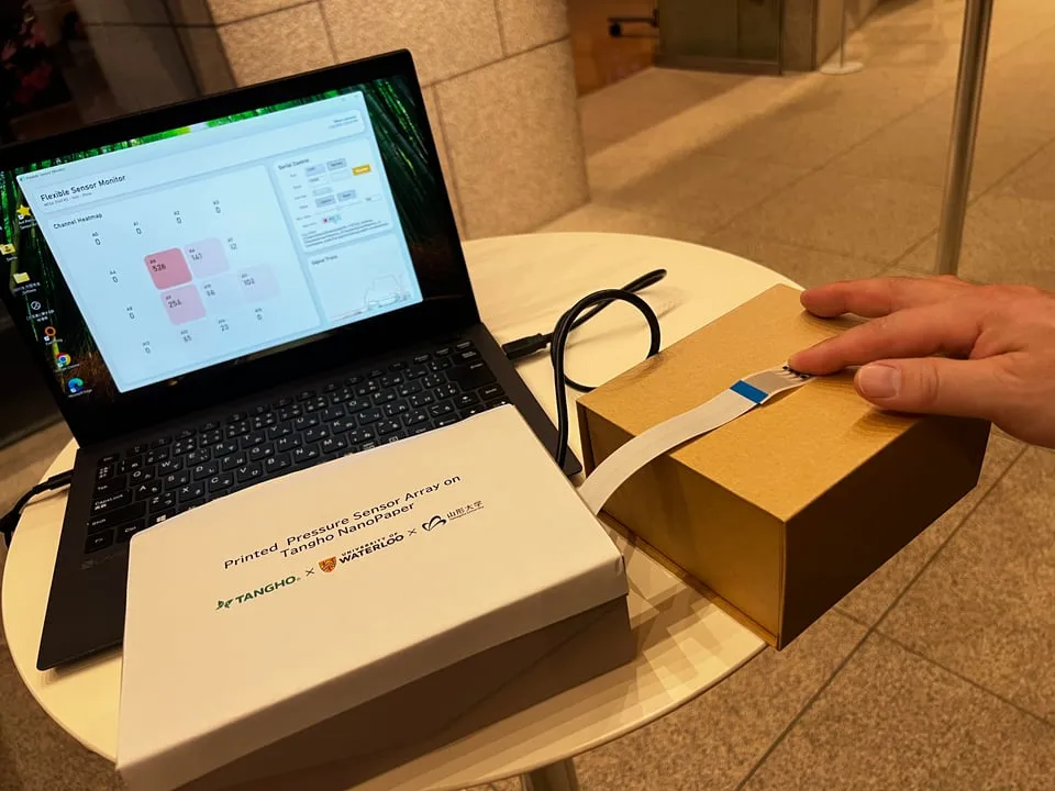 NanoPaper pressure sensor connected to a laptop displaying a force map.