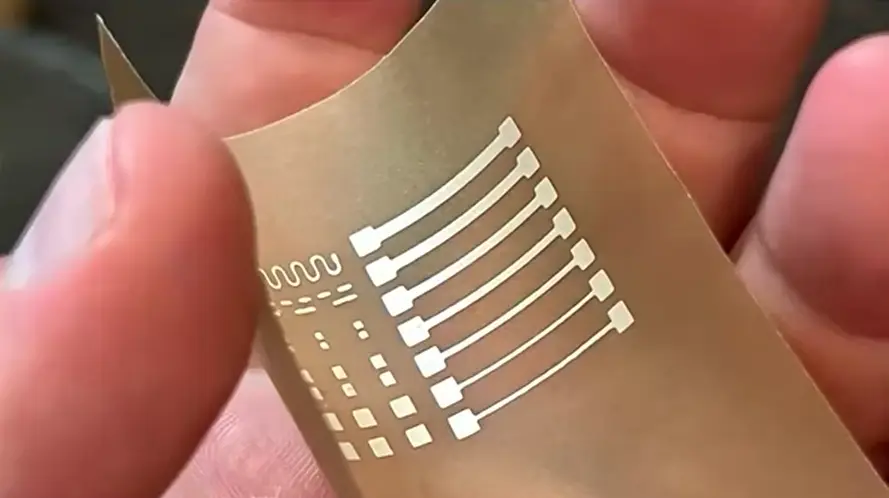 NanoPaper printed conductive patterns held between two fingers.
